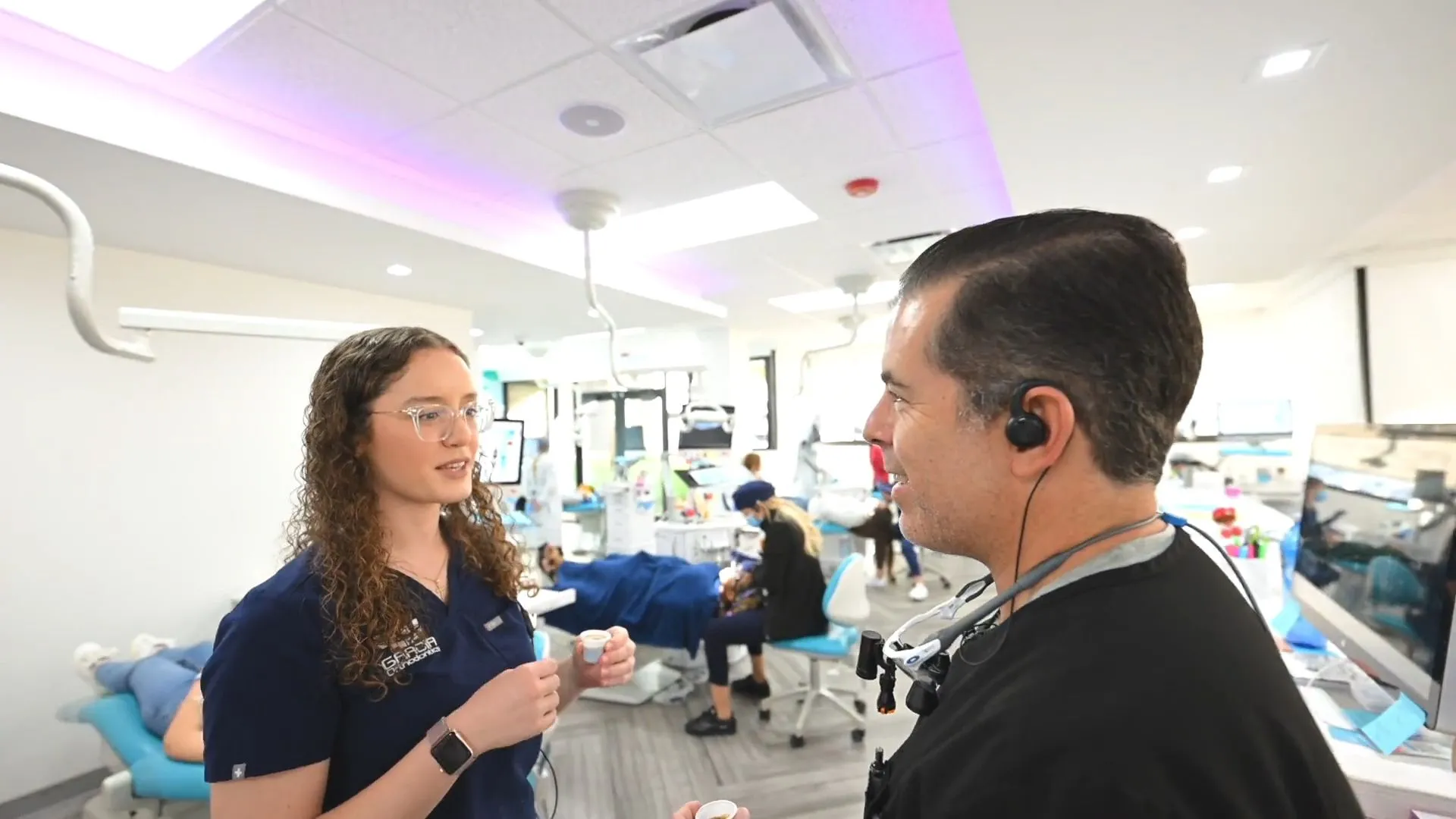 Dr. Garcia talking with a team member in the office